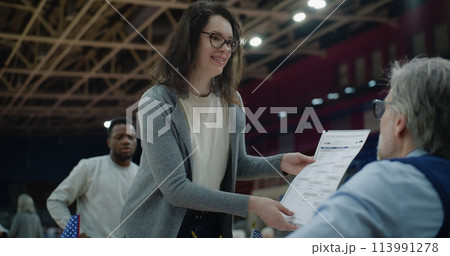 American citizen comes to vote in polling station, take bulletins 113991278