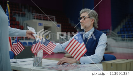 American citizen comes to vote in polling station, take bulletins American citizen comes to vote in polling station, take bulletins 113991384