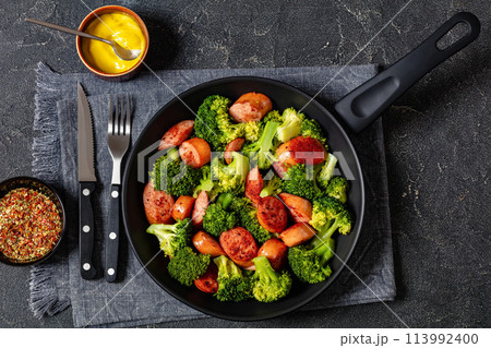 fried juicy sausage and crispy broccoli in skillet fried juicy sausage and crispy broccoli in skillet 113992400