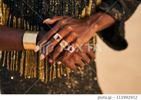 Gender fluid biracial gay hands with jewelry rings, bracelets. Bipoc trans model poses with manicure in closeup. Androgynous drag person touches hands tenderly. Transgender shows his identity. Pride. Gender fluid biracial gay hands with jewelry rings, bracelets. Bipoc trans model poses with manicure in closeup. Androgynous drag person touches hands tenderly. Transgender shows his identity. Pride. 113992912