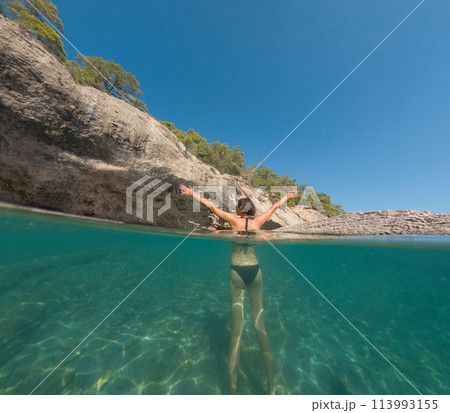 Woman on tropical vacation paradise on sea. Summer sea joy in Turkish seacoast, beaches along Lycian Way, Turkish Riviera. Asian female underwater and turquoise ocean around. 113993155