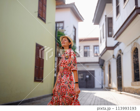 female summer travel to Antalya, Turkey. young asian woman in red dress walk through old town Kalechi , female tourist traveler discover interesting places and popular tourist attraction female summer travel to Antalya, Turkey. young asian woman in red dress walk through old town Kalechi , female tourist traveler discover interesting places and popular tourist attraction 113993193