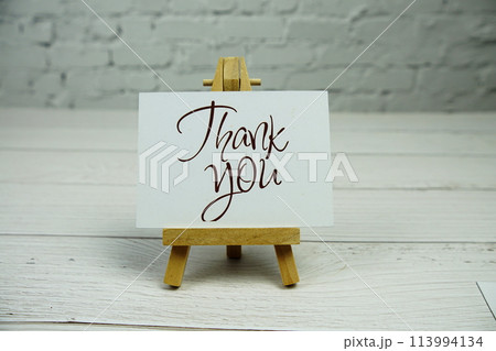 Thank You text on paper card with wooden easel stand 113994134