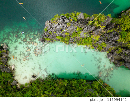 Big Lagoon with clear water and kayaks. Miniloc Island. El Nido, Palawan. Philippines. Big Lagoon with clear water and kayaks. Miniloc Island. El Nido, Palawan. Philippines. 113994142