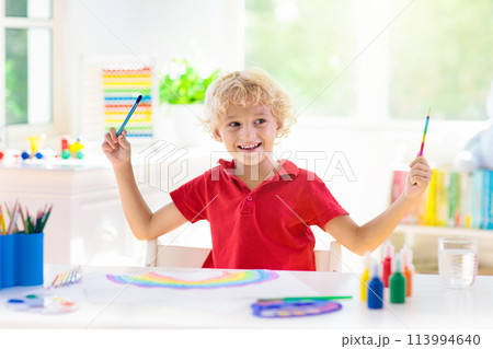 Kids paint. Child painting. Little boy drawing. 113994640