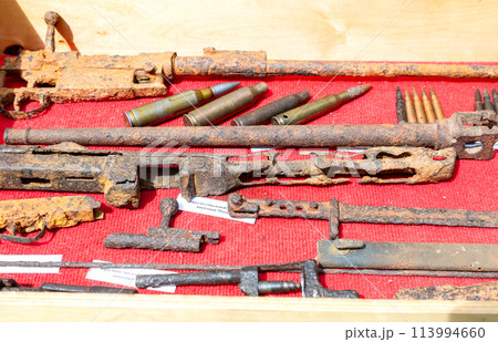 Rusty remains of weapons and ammunition from the Second World War Rusty remains of weapons and ammunition from the Second World War 113994660