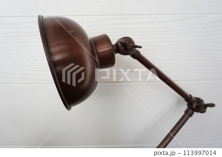 close up of metal desk lamp with space copy on concreat background home interier decoration 113997014