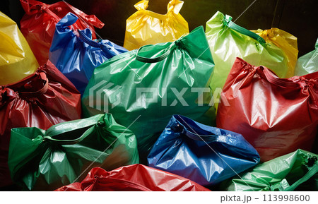 Colorful full plastic bags close-up on dark background 113998600