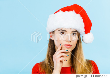 Thinking woman wearing Santa Claus helper costume Thinking woman wearing Santa Claus helper costume 114005432