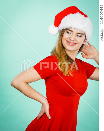 Positive woman wearing Santa Claus helper costume Positive woman wearing Santa Claus helper costume 114005443