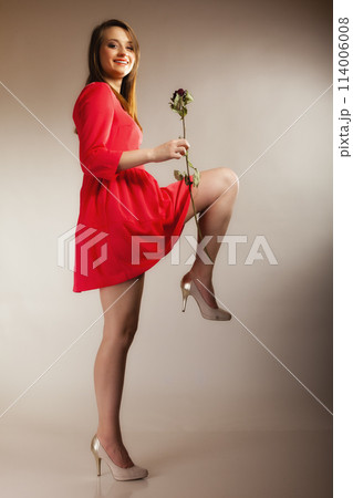 Fashion woman teen girl in red gown with dry rose. Fashion woman teen girl in red gown with dry rose. 114006008