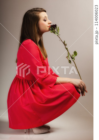 Fashion woman teen girl in red gown with dry rose. Fashion woman teen girl in red gown with dry rose. 114006023