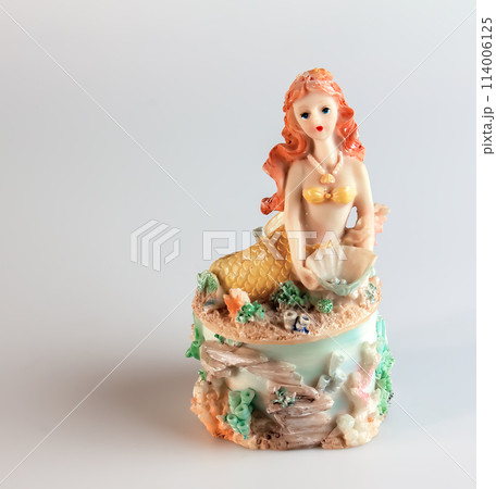 Mermaid figurine on a white background. Fairytale character. Toy mermaid. Feminine appearance 114006125