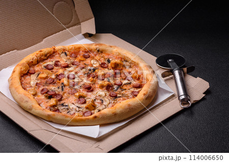 Delicious pizza with sausage, cheese, tomatoes, salt, spices and herbs 114006650