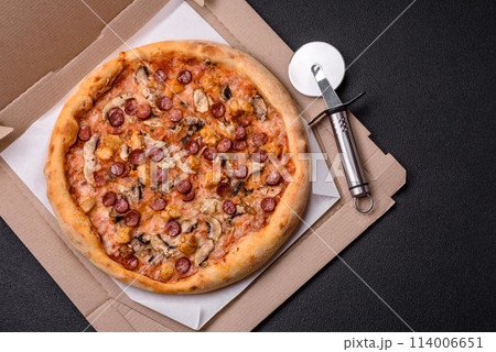 Delicious pizza with sausage, cheese, tomatoes, salt, spices and herbs 114006651