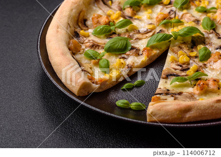 Delicious pizza with corn, cheese, tomatoes and mushrooms, salt, spices and herbs Delicious pizza with corn, cheese, tomatoes and mushrooms, salt, spices and herbs 114006712