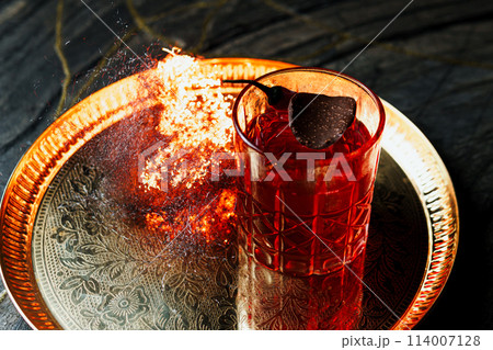 Alcoholic drink. A cocktail with elite alcohol on dark black background 114007128