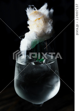 Alcoholic drink. A cocktail with elite alcohol on dark black background 114007137