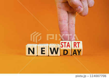 New day and start symbol. Concept word New day New start on beautiful wooden cubes. Beautiful orange table orange background. Businessman hand. Business new day and start concept. Copy space. New day and start symbol. Concept word New day New start on beautiful wooden cubes. Beautiful orange table orange background. Businessman hand. Business new day and start concept. Copy space. 114007706