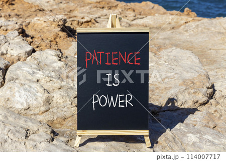 Patience is power symbol. Concept words Patience is power on beautiful black chalk blackboard. Beautiful red stone blue sea background. Business and patience is power concept. Copy space. 114007717