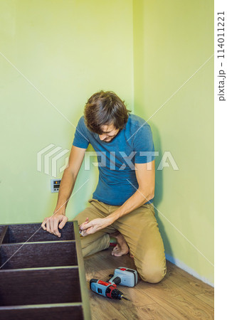 Frustrated Man Putting Together Self Assembly Furniture 114011221