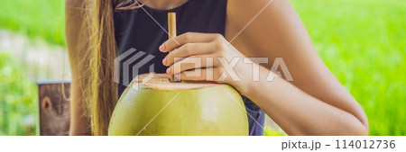 Young woman with fresh coconut cocktail in the background of a rice field BANNER, LONG FORMAT Young woman with fresh coconut cocktail in the background of a rice field BANNER, LONG FORMAT 114012736