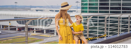 BANNER, LONG FORMAT Family at airport before flight. Mother and son waiting to board at departure gate of modern international terminal. Traveling and flying with children. Mom with kid boarding 114012783
