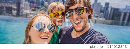 Vacation and technology. Happy family with kid taking selfie together near swimming pool with panoramic views of the city BANNER, LONG FORMAT 114012848