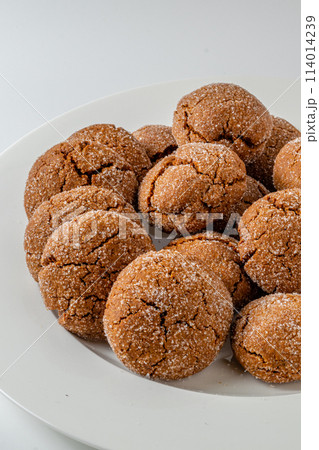 Warm Homemade Gingersnap Cookies on a light background in a plate 114014239