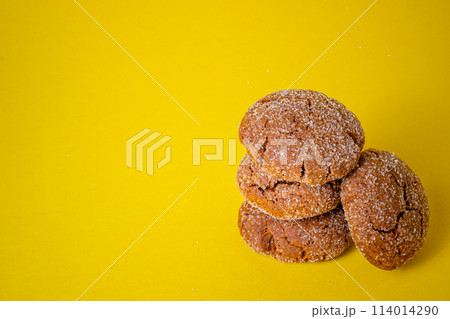 Warm Homemade Gingersnap Cookies yellow background 114014290