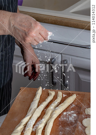 Woman kneading dough in kitchen Woman kneading dough in kitchen 114014312