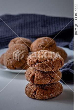 Warm Homemade Gingersnap Cookieson a light background, a gray handkerchief Warm Homemade Gingersnap Cookieson a light background, a gray handkerchief 114014368
