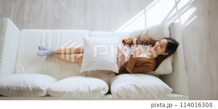 High angle view of happy cheerful positive young Asian woman on the phone at home 114016308