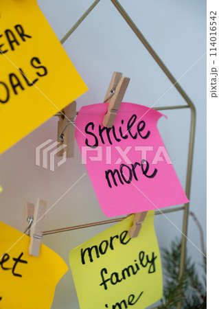 SMILE MORE self care goal on Action board new year's resolutions on colorful sticky notes. Making promises for new year, setting goals. Dream year SMILE MORE self care goal on Action board new year's resolutions on colorful sticky notes. Making promises for new year, setting goals. Dream year 114016542