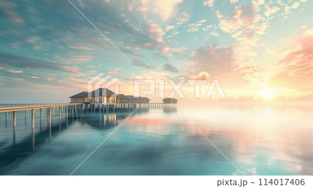 Tranquil beach view featuring water villas and a long wooden pier jutting into reflective sea waters 114017406