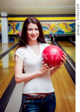 Beautiful girl at the bowling alley with the ball. Beautiful girl at the bowling alley with the ball. 114021104