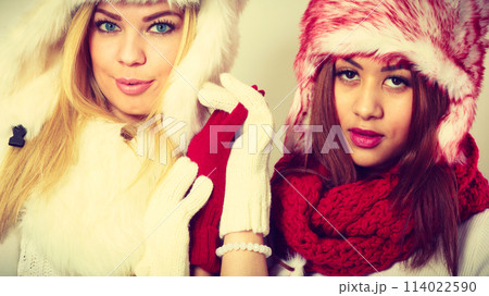 Two girls in warm winter clothing portrait. Two girls in warm winter clothing portrait. 114022590