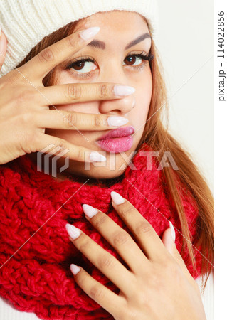 Mulatto woman in warm winter clothing showing nails 114022856