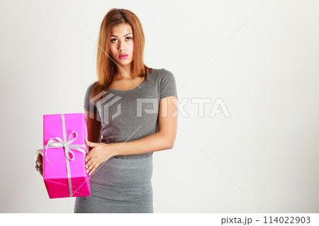 Beautiful woman with pink gift. Beautiful woman with pink gift. 114022903