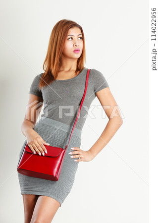 Mulatto girl gray wear with red handbag 114022956