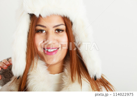 Mulatto woman in winter outfit. 114022975