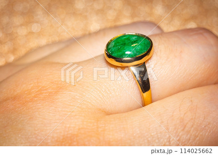 Gold ring with green stone 114025662