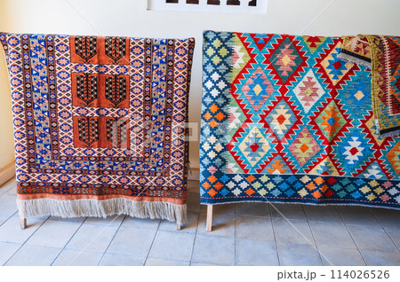 Colorful expensive vintage oriental Arabic carpets on market in Uzbekistan 114026526