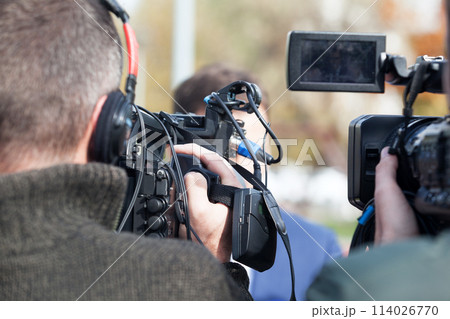 TV interview. News conference. TV interview. News conference. 114026770