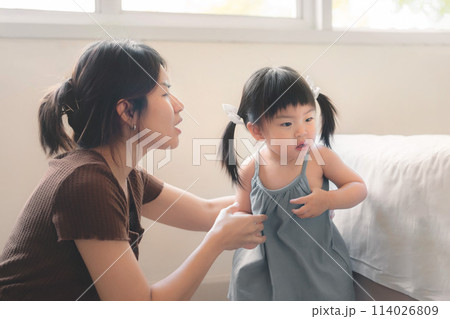 Asian mother disciplining her child, Asian girl kid being defiant with mom, Terrible two concept. 114026809