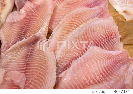 Fresh fish lies on ice in a supermarket 114027384
