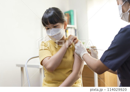 Asian Preteen Girl Getting Vaccinated, Receiving Coronavirus Vaccine Injection in clinic. Asian Preteen Girl Getting Vaccinated, Receiving Coronavirus Vaccine Injection in clinic. 114029920