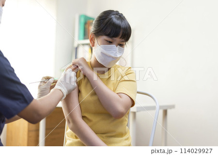 Asian Preteen Girl Getting Vaccinated, Receiving Coronavirus Vaccine Injection in clinic. Asian Preteen Girl Getting Vaccinated, Receiving Coronavirus Vaccine Injection in clinic. 114029927