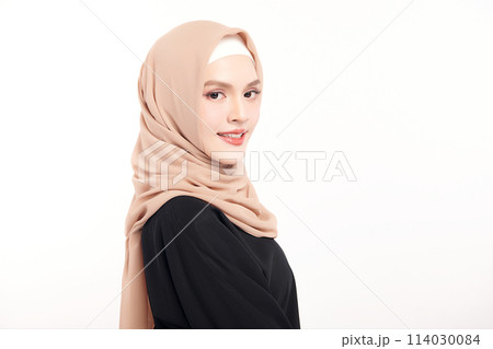 Beautiful young asian muslim woman wearing a beige hijab on white background, Portrait of Arab Beauty. 114030084