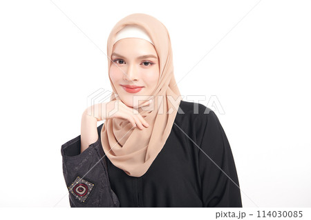 Beautiful young asian muslim woman wearing a beige hijab on white background, Portrait of Arab Beauty. 114030085
